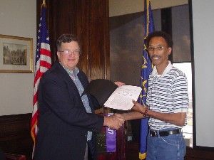 Capt. Whitkop (l) presents a letter of commendation to Frank O'Dell for his honor as the chapter's Information Professional of the Month in July.